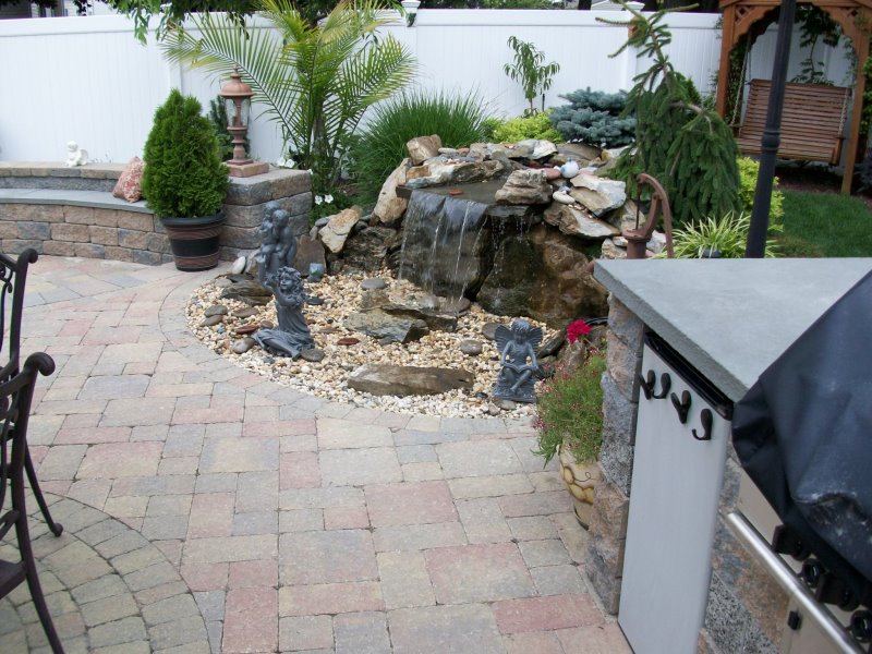 moss rock pondless waterfall and patio